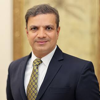 Dr. Nileshkumar M. Chaudhari portrait in a formal suit with a confident and professional expression.